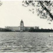 Image of the Legislative Building from afar, a lake is in front of it.
