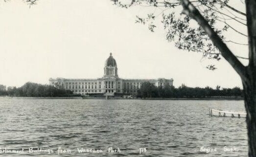 Image of the Legislative Building from afar, a lake is in front of it.